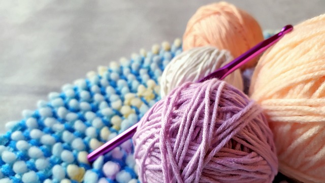 A crochet project with a 
			 crochet hook and yarn balls
